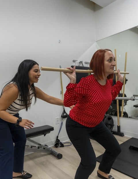 Women exercising in a gym, fitness training.