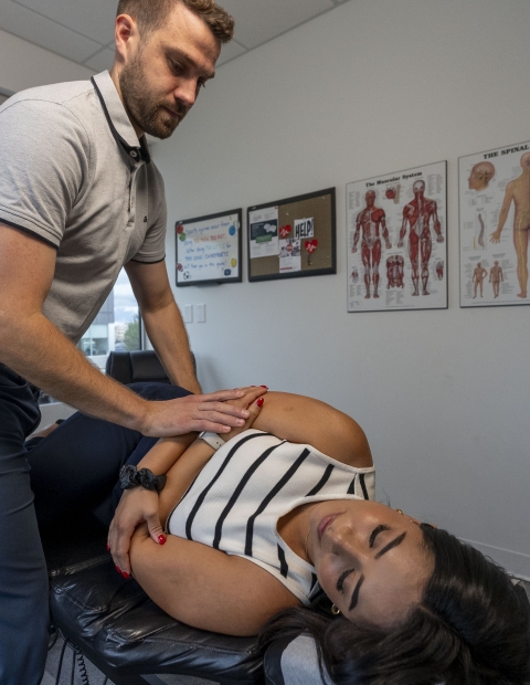 A chiropractor cracking a woman's back.