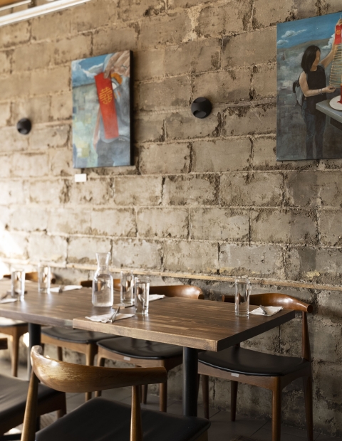 A cozy restaurant with a neatly set table and comfortable chairs