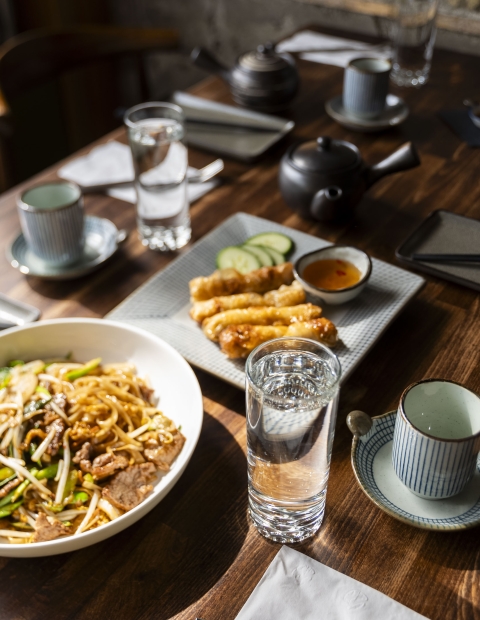 A table with bowls of food and a plate with tempura 