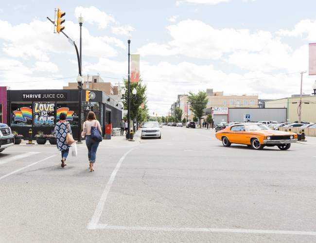 Two women crossing the street in downtown Saskatoon