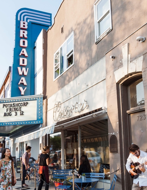 a crowd of people outside the Broadway theatre. 