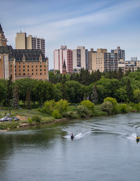 two individuals using jetskis on the South Saskatchewan River