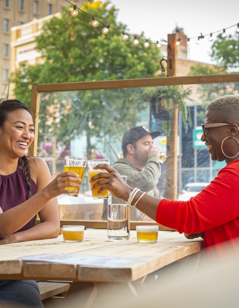 Women sitting on a restaurant patio having drinks