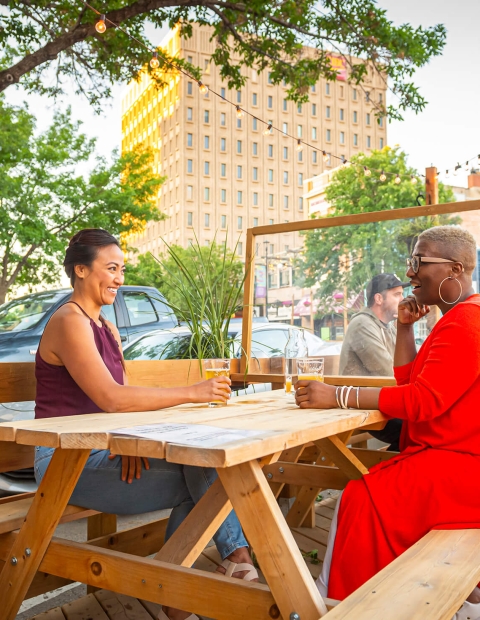 women sitting at an outdoor patio table at a restaurant