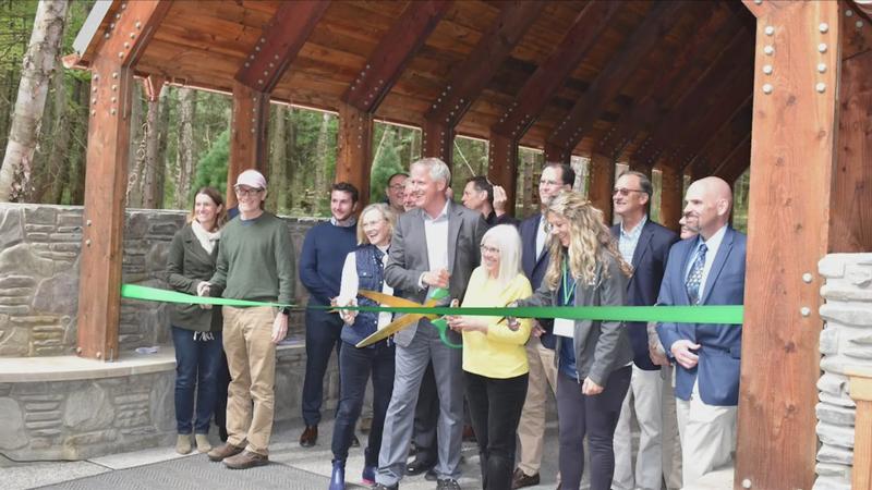 group of people cutting a ribbon during a ceremony