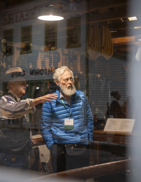 Two men standing in front of a horse figure at the Western Development Museum