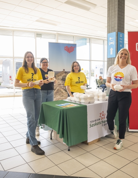 Women standing in front of stall at a conference