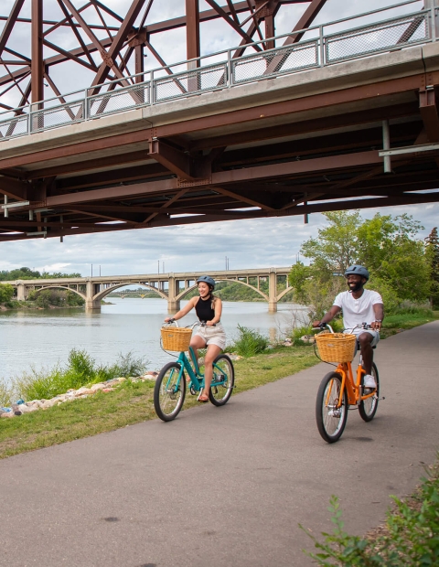 a couple riding bikes in a park