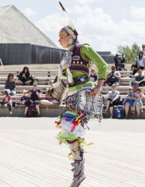 Indigenous woman dancing in traditional clothing